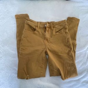 dusty yellow American eagle next level stretch jeans